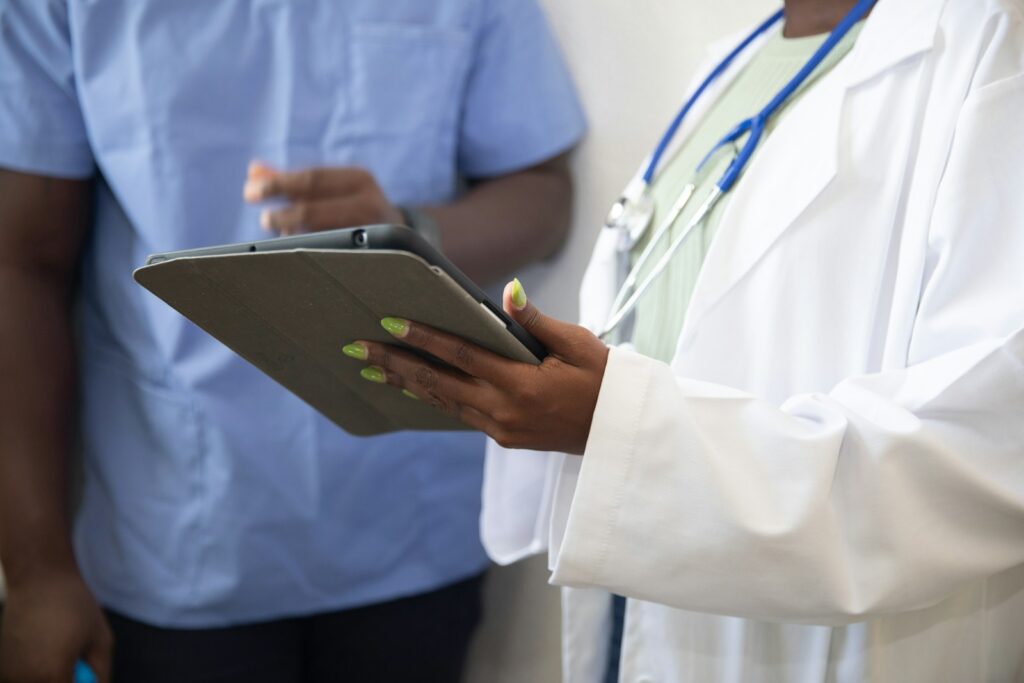 Doctor reviewing information on a tablet with a colleague