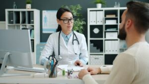 Physician listening to a patient at her desk